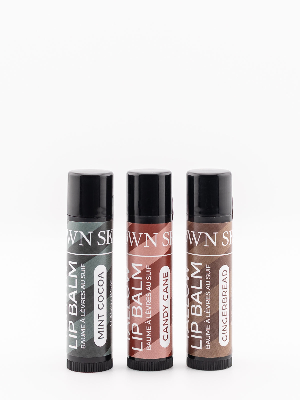 Three Christmas Special Lip Balms Made with Beef Tallow in the flavours Candy Cane, Gingerbread and Mint Cocoa on a white background