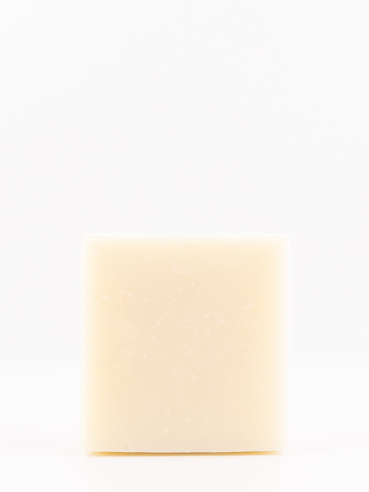 A single rectangular bar of artisan beef tallow cream-colored soap standing upright against a seamless white background.