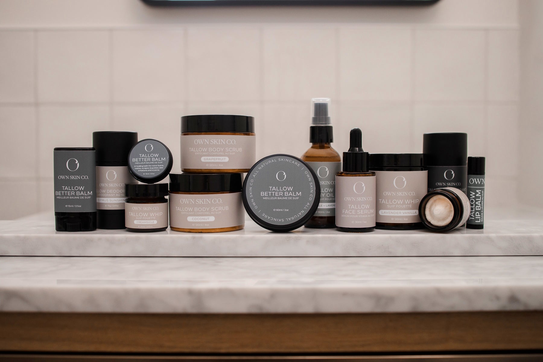 OWN Skin Co Wholesale Skincare lined up on marble counter