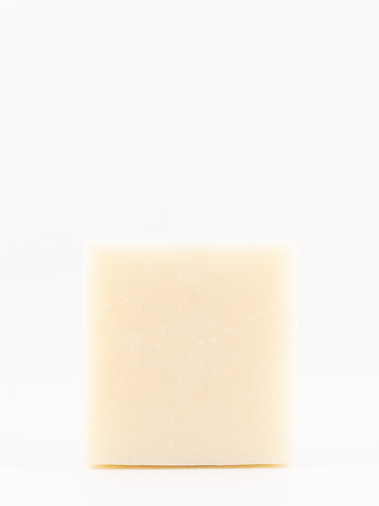 A single rectangular bar of artisan beef tallow cream-colored soap standing upright against a seamless white background.