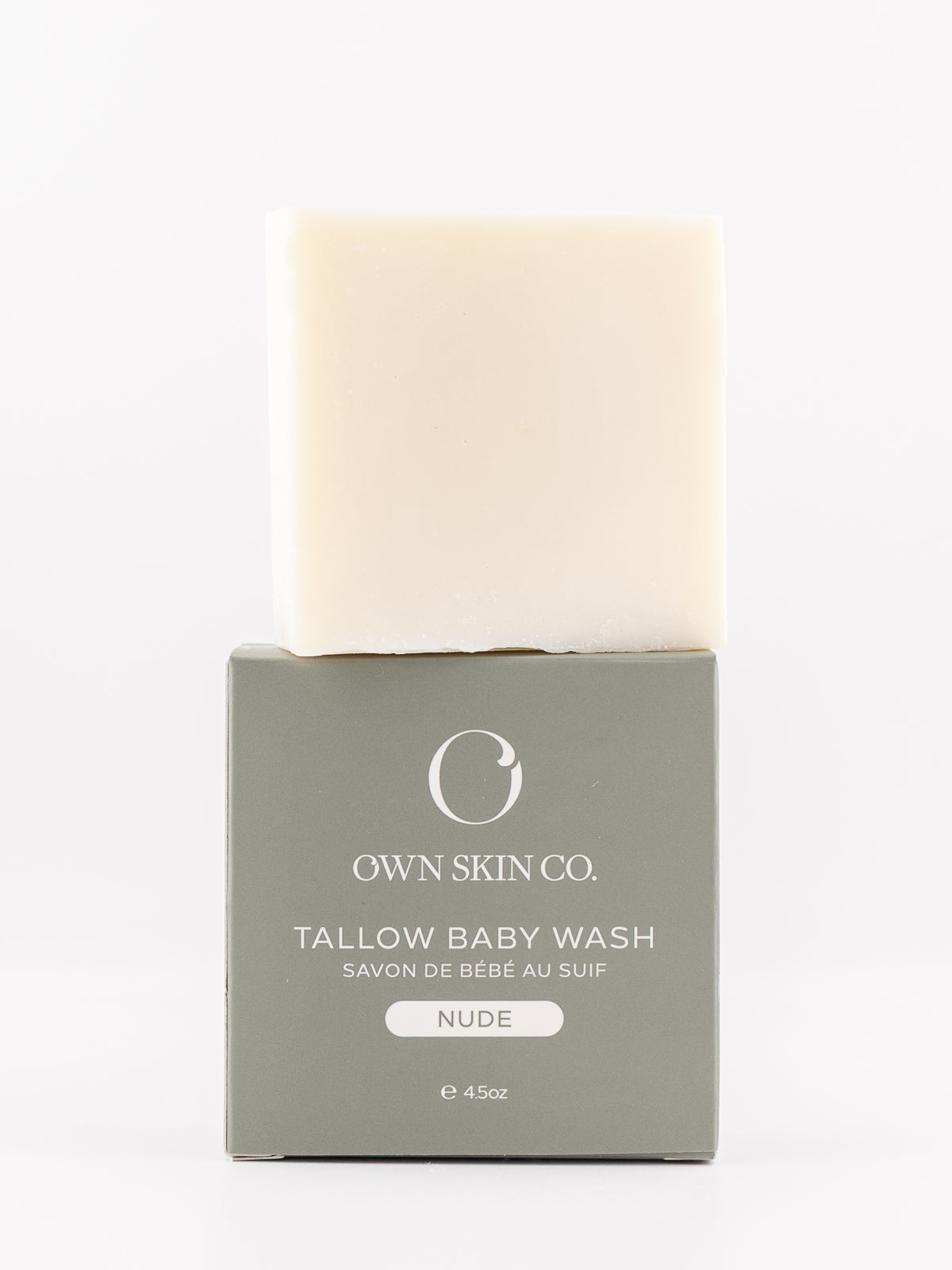 Own Skin Co. Tallow Baby Wash in the shade NUDE, featuring a solid cream-colored bar of soap resting on its matte gray packaging box against a clean white background.