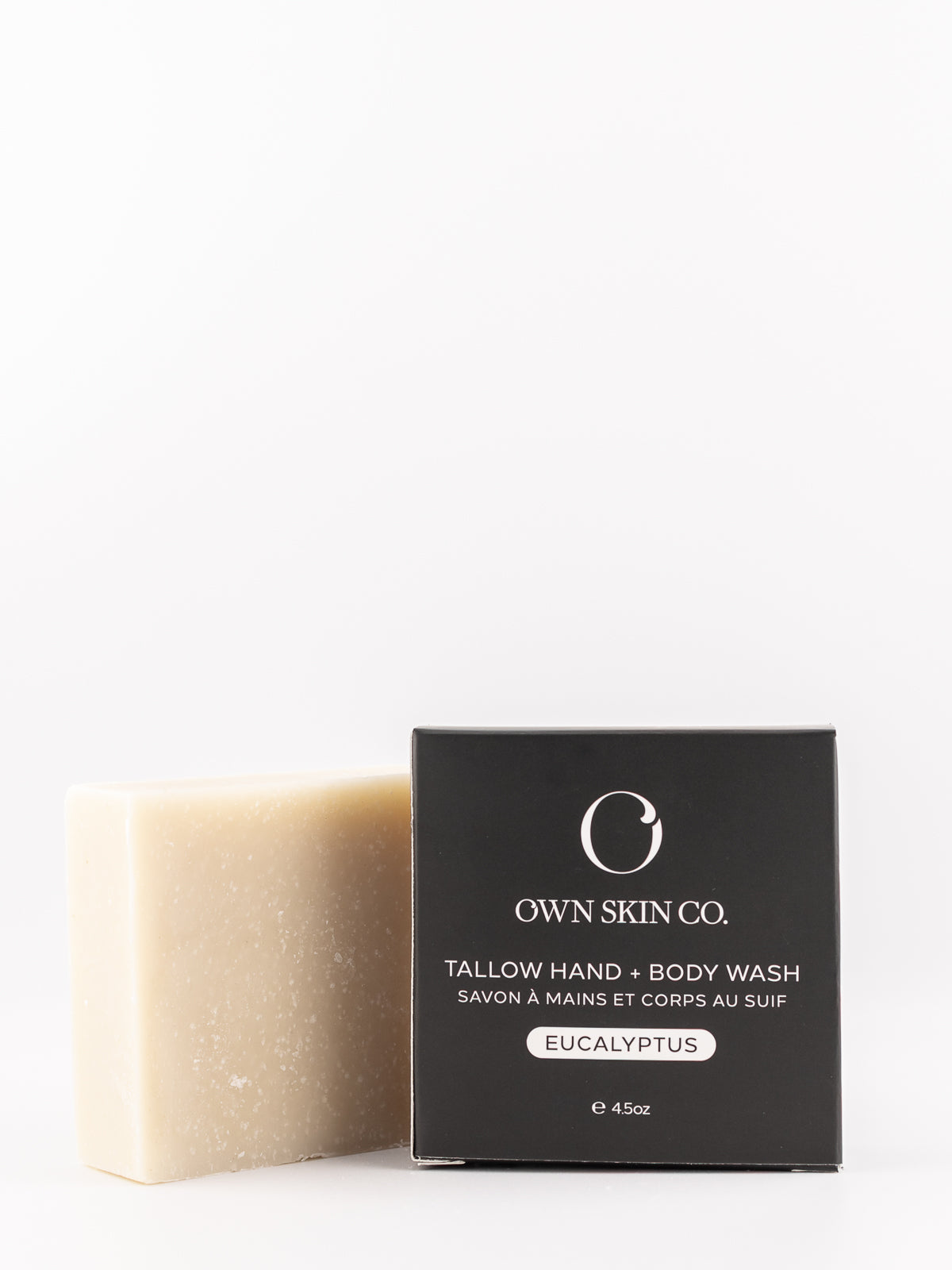A bar of Own Skin Co. Tallow Hand & Body Wash in Eucalyptus scent, shown next to its black packaging box on a clean white background.