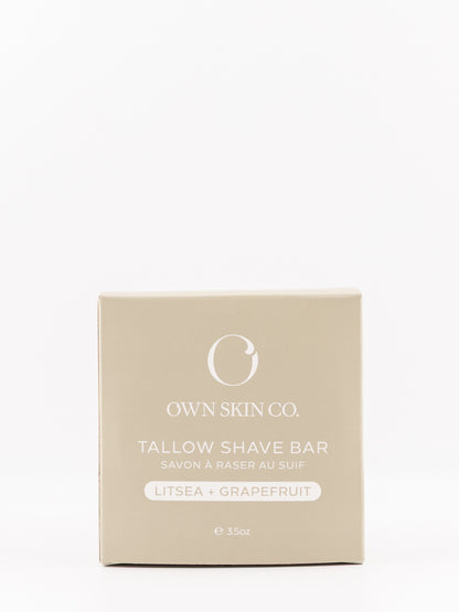 Own Skin Co. Tallow Shave Bar packaging box in a light beige color, featuring white text and logo, on a seamless white background.
