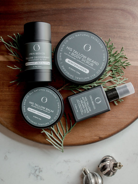 Collection of men's beef tallow grooming products and skincare on a wooden board with christmas greenery