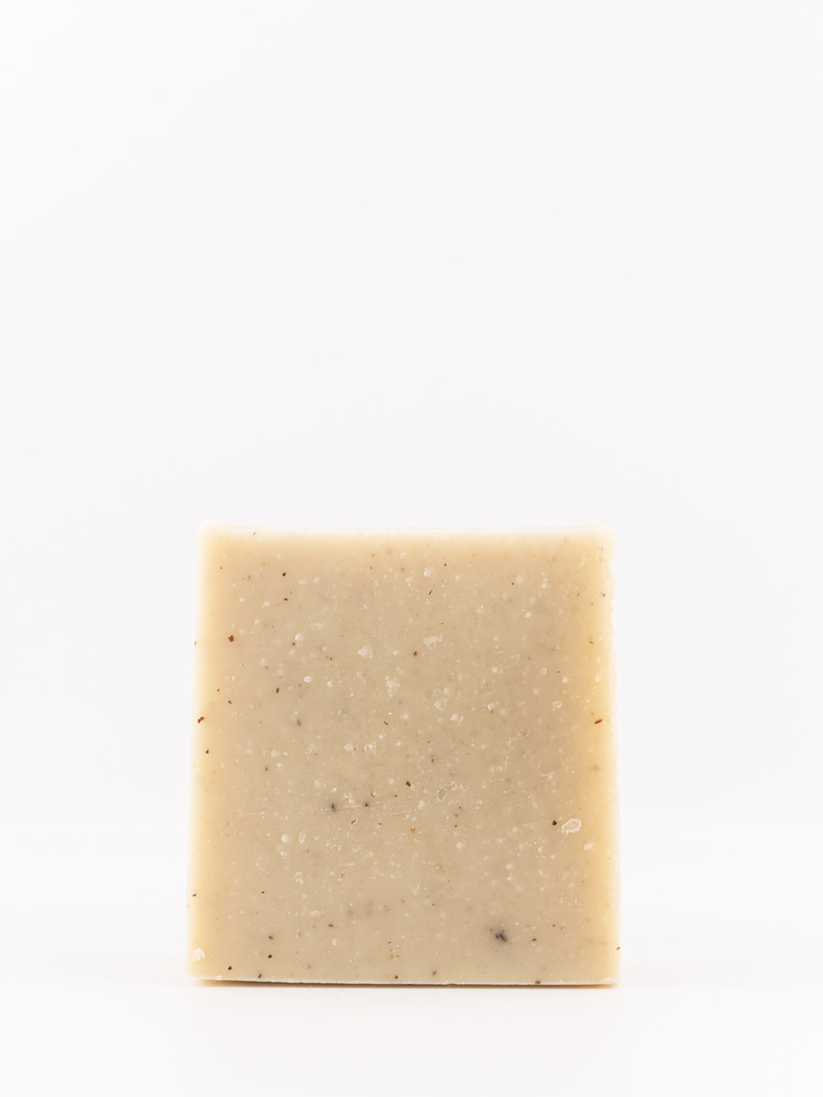 a speckled artisan handmade soap bar with little speckles in mountain breeze men's scent on a white background. 