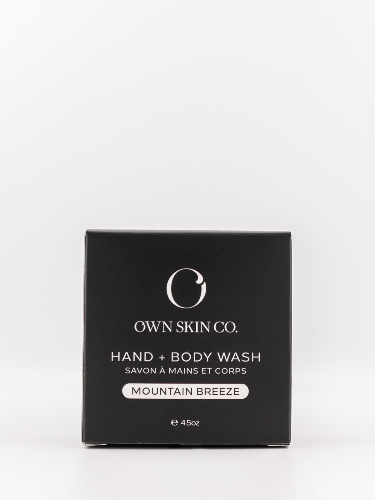 Own Skin Co. Mountain Breeze Hand & Body Wash in a square black box with white text, photographed on a clean white background.