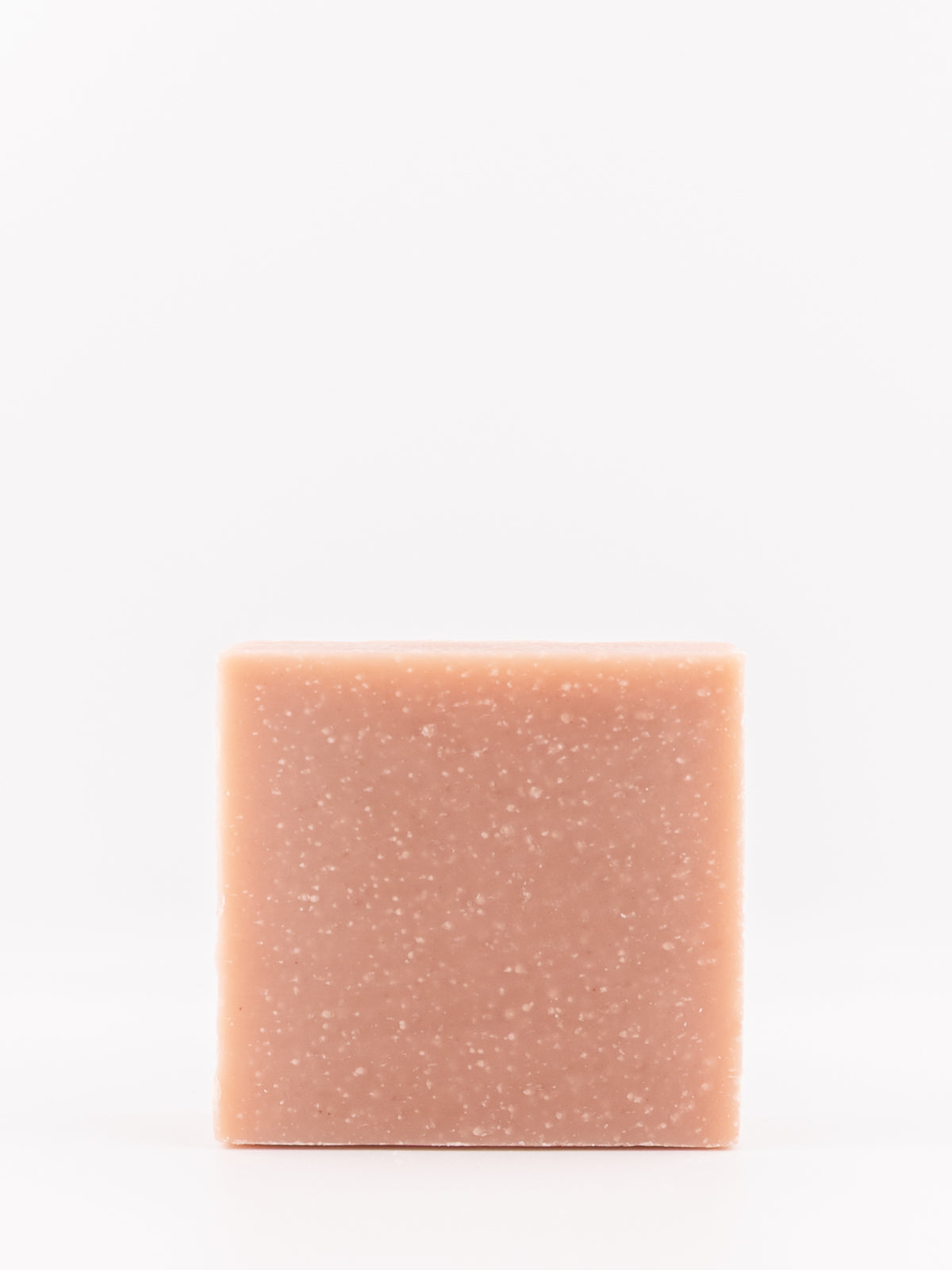 A single rectangular bar of tallow soap with a dusty rose pink coloru and fine white speckles, centered against a plain white background.