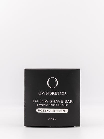 Own Skin Co. Tallow Shave Bar in a square black box with white text, labeled Rosemary + Mint, on a clean white background.