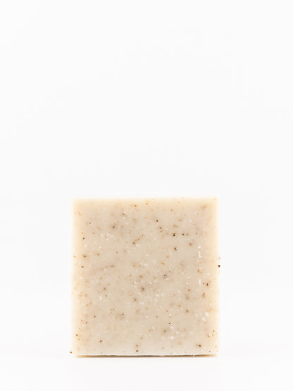A rectangular bar of own skin's men's rosemary mint body wash. A light beige soap with small brown and white specks, centered against a solid white background.