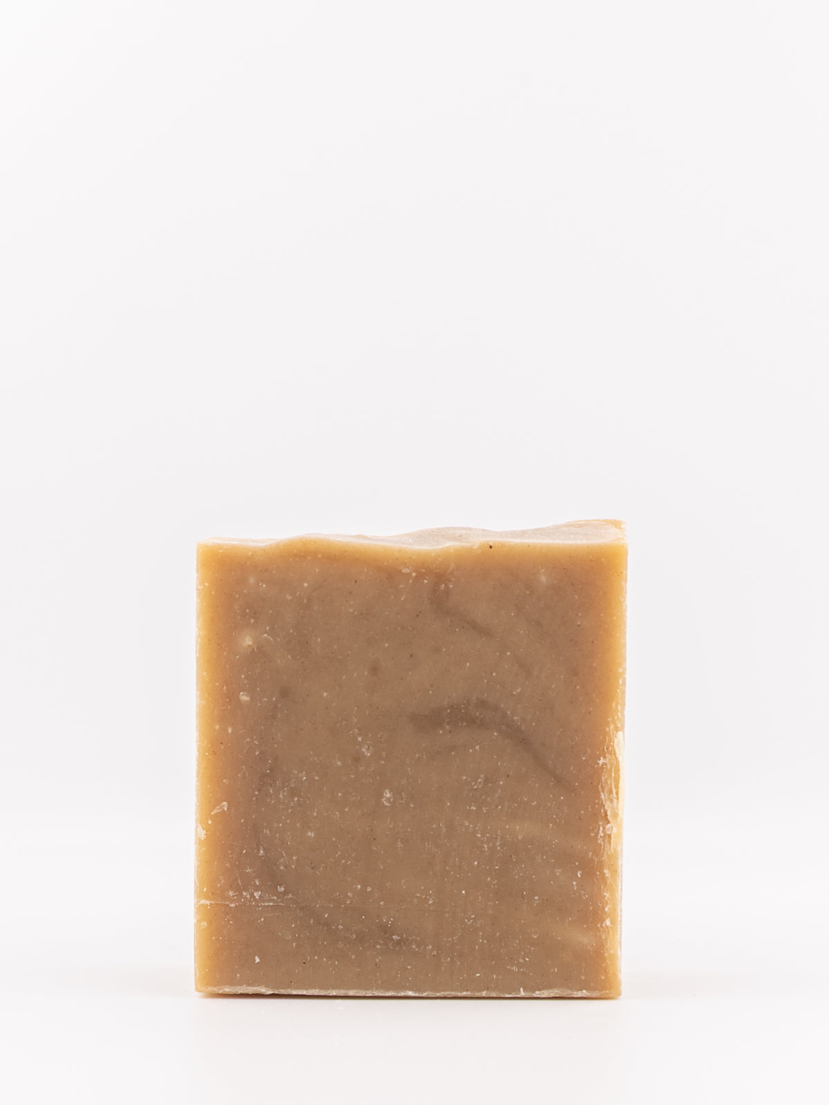 A rectangular bar of handmade soap in gingerbread scent with a warm brown and tan marbled texture, photographed against a seamless white background.